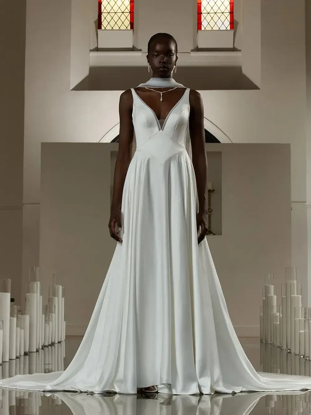 model is wearing a sleeveless a-line bridal gown