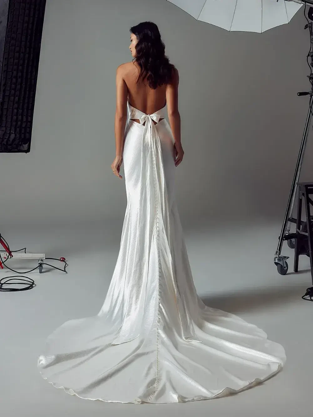 model is wearing a sleeveless fit and flare bridal gown