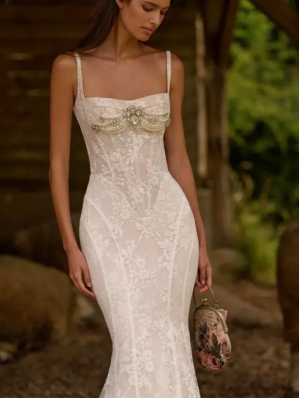 model is wearing a sleeveless sheath bridal gown