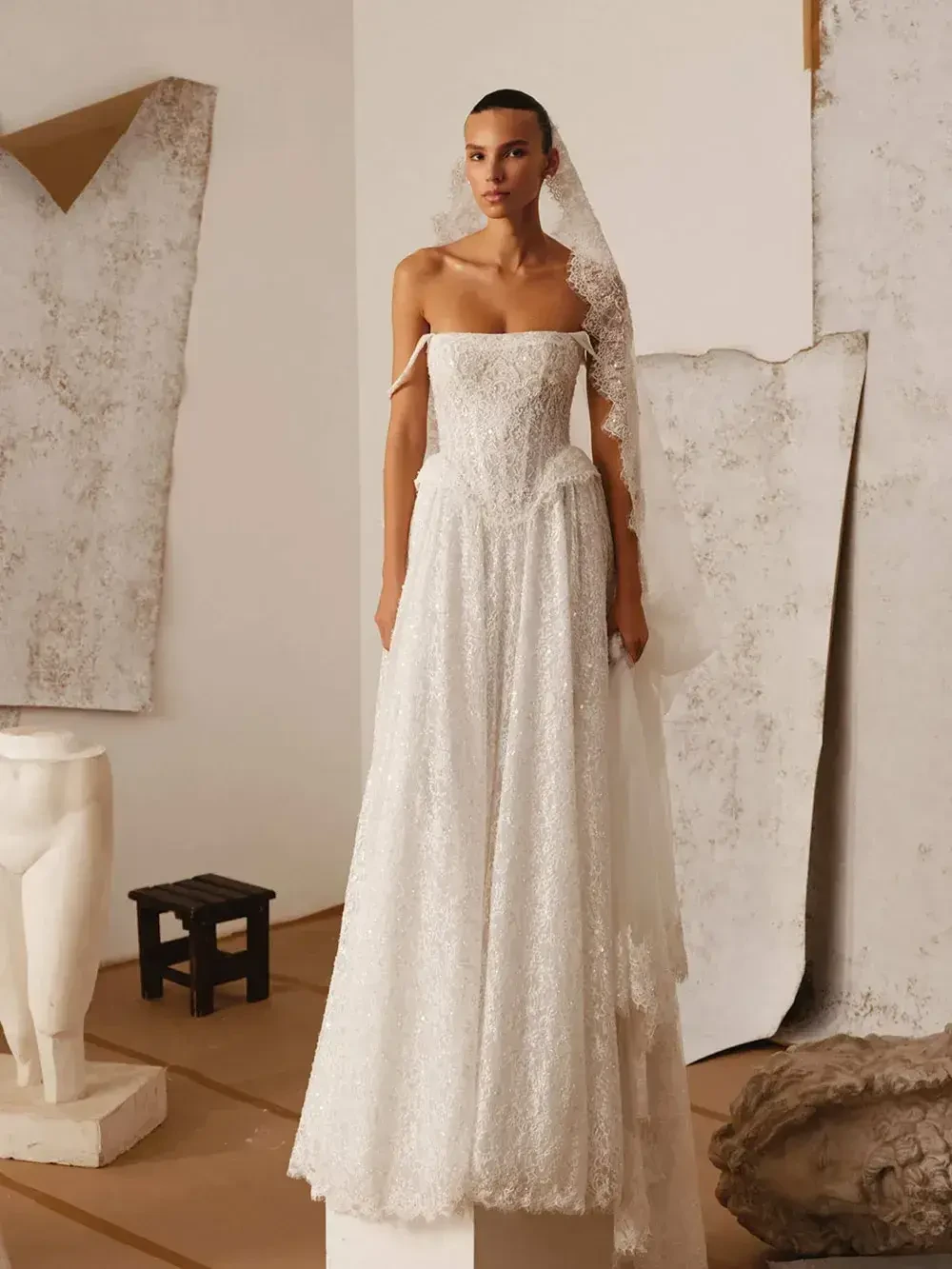 model is wearing a strapless a-line wedding gown