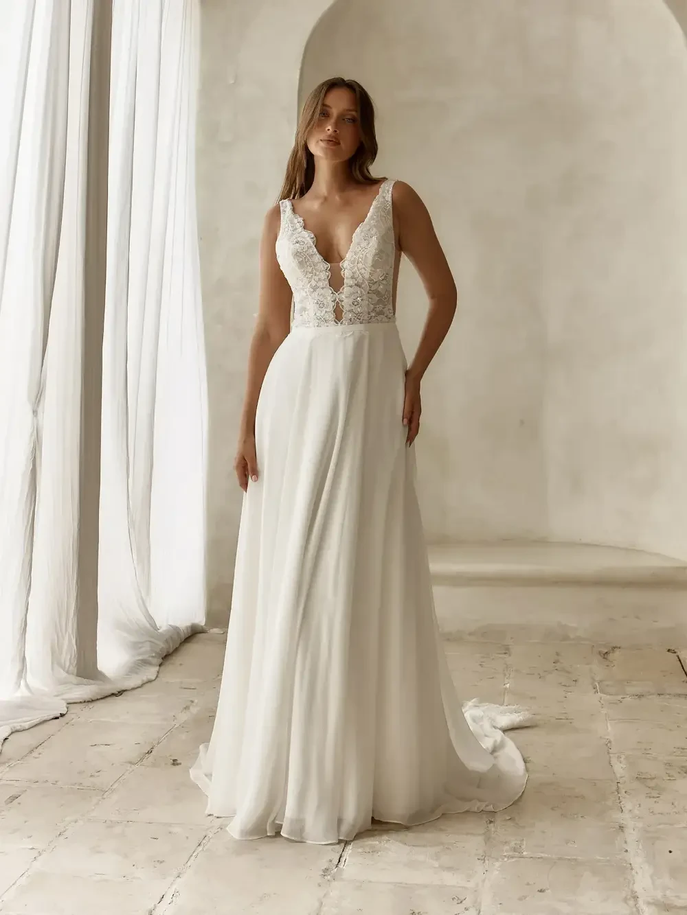 model is wearing a sleeveless a-line bridal gown