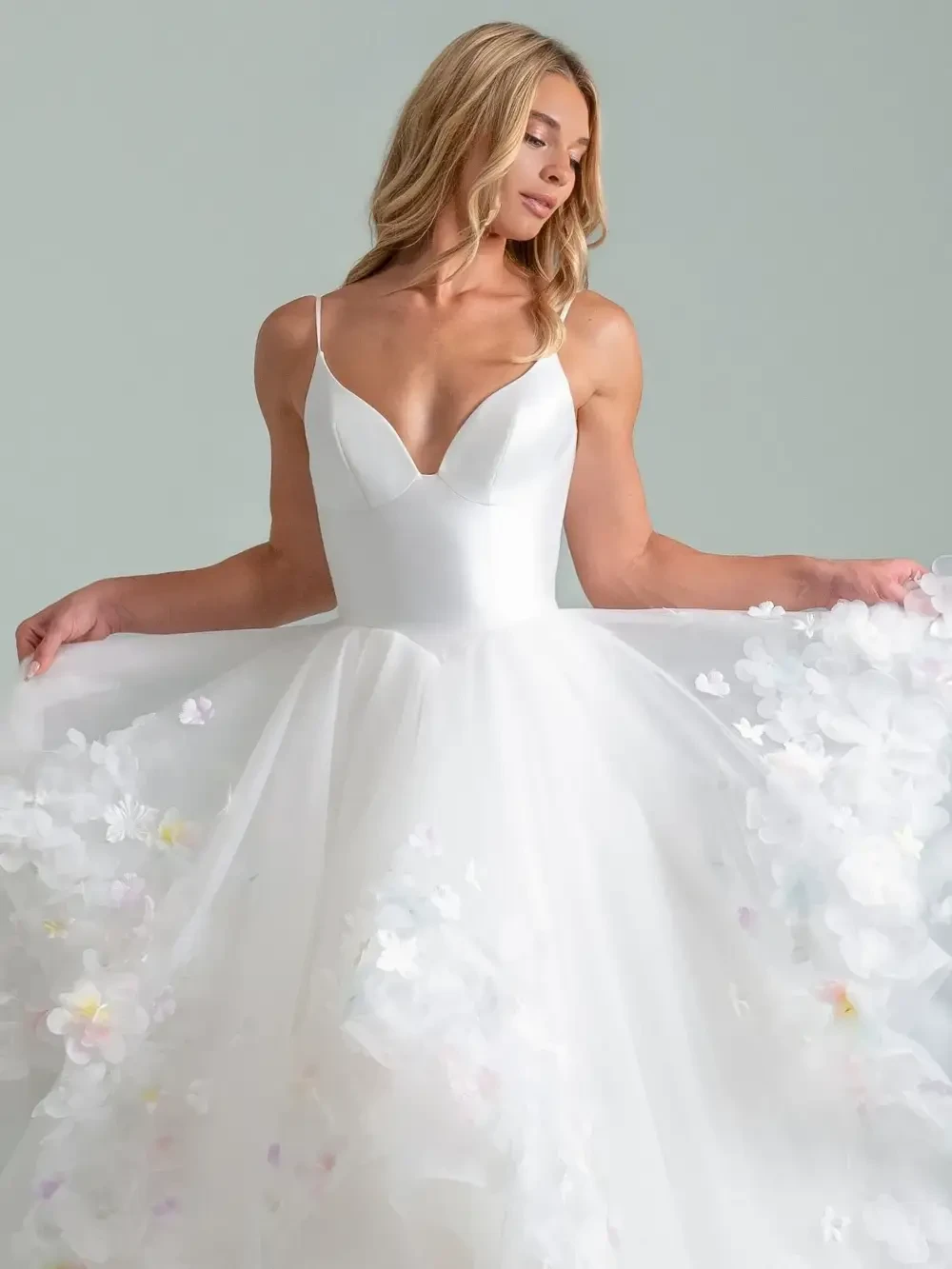 model is wearing a spaghetti strap bridal gown