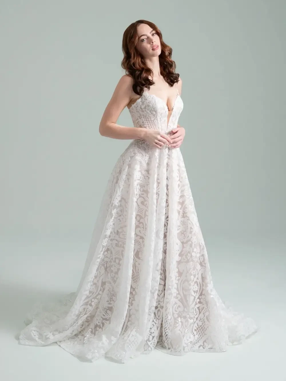 model is wearing a sleeveless lace bridal gown
